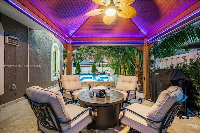 view of patio / terrace with a gazebo, ceiling fan, area for grilling, and a fenced in pool