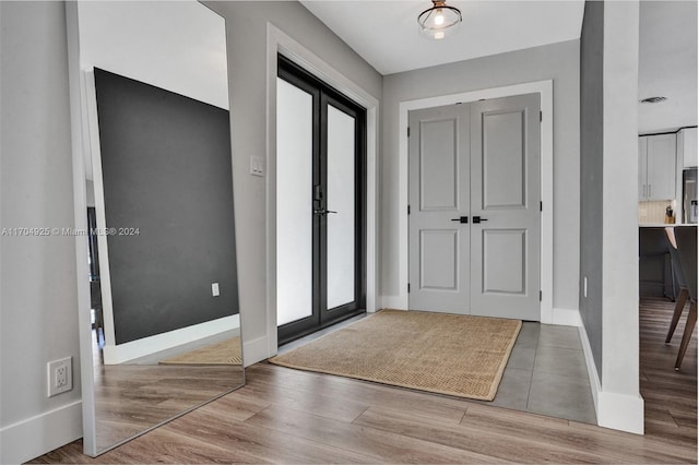 foyer entrance featuring wood-type flooring and french doors