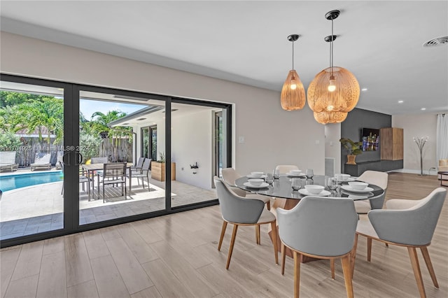 dining area with light hardwood / wood-style flooring and french doors