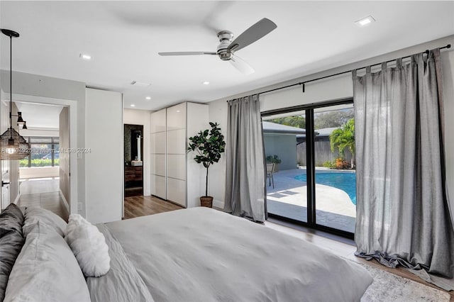 bedroom with access to exterior, ceiling fan, and hardwood / wood-style floors