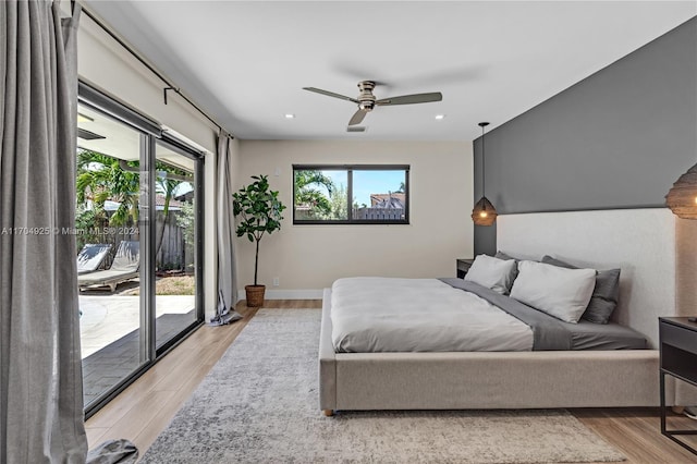 bedroom featuring ceiling fan, light hardwood / wood-style flooring, access to outside, and multiple windows