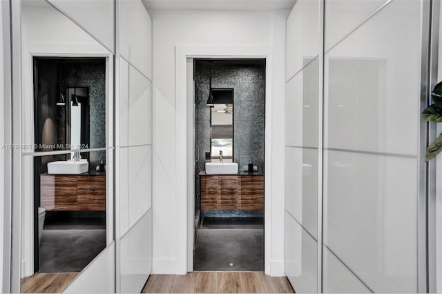 hallway featuring light hardwood / wood-style flooring and sink