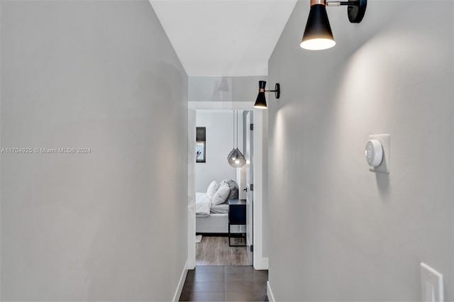 hallway with dark hardwood / wood-style flooring