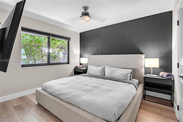 bedroom featuring ceiling fan and light wood-type flooring