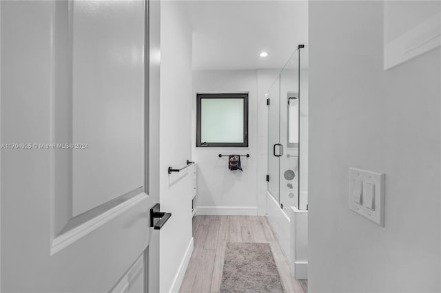 bathroom featuring hardwood / wood-style floors and shower with separate bathtub