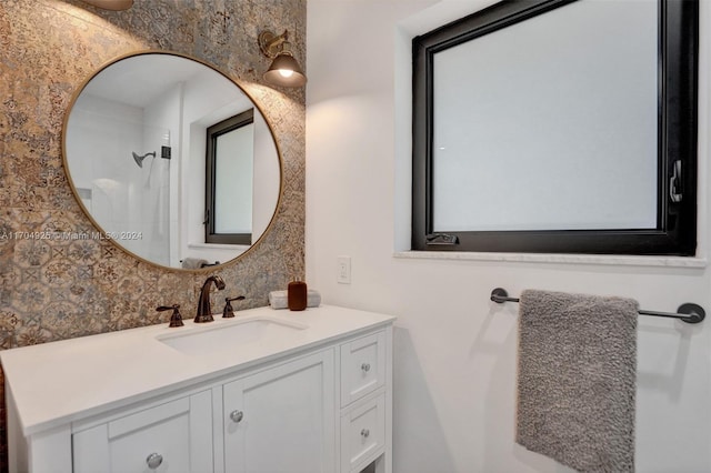 bathroom with vanity and a shower