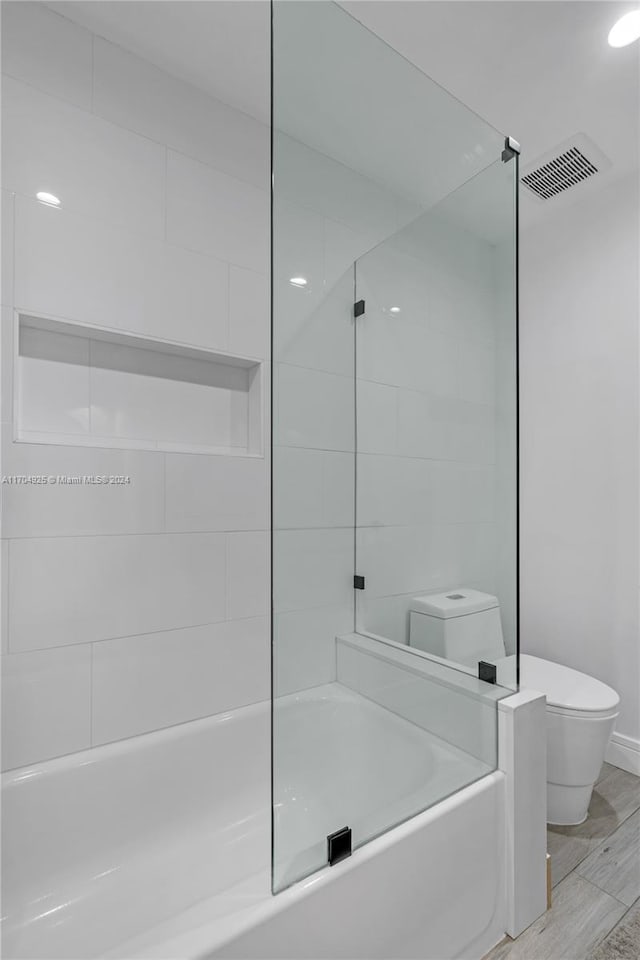 bathroom featuring hardwood / wood-style floors and toilet