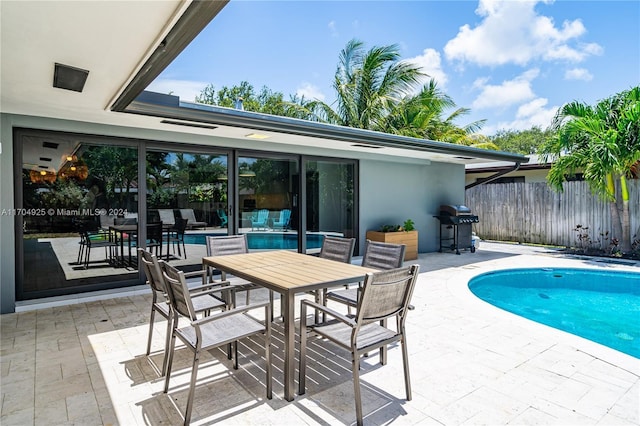 view of pool featuring area for grilling and a patio area