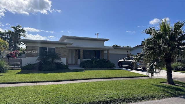 single story home featuring a garage and a front lawn