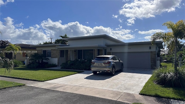 view of front facade with a garage and a front lawn