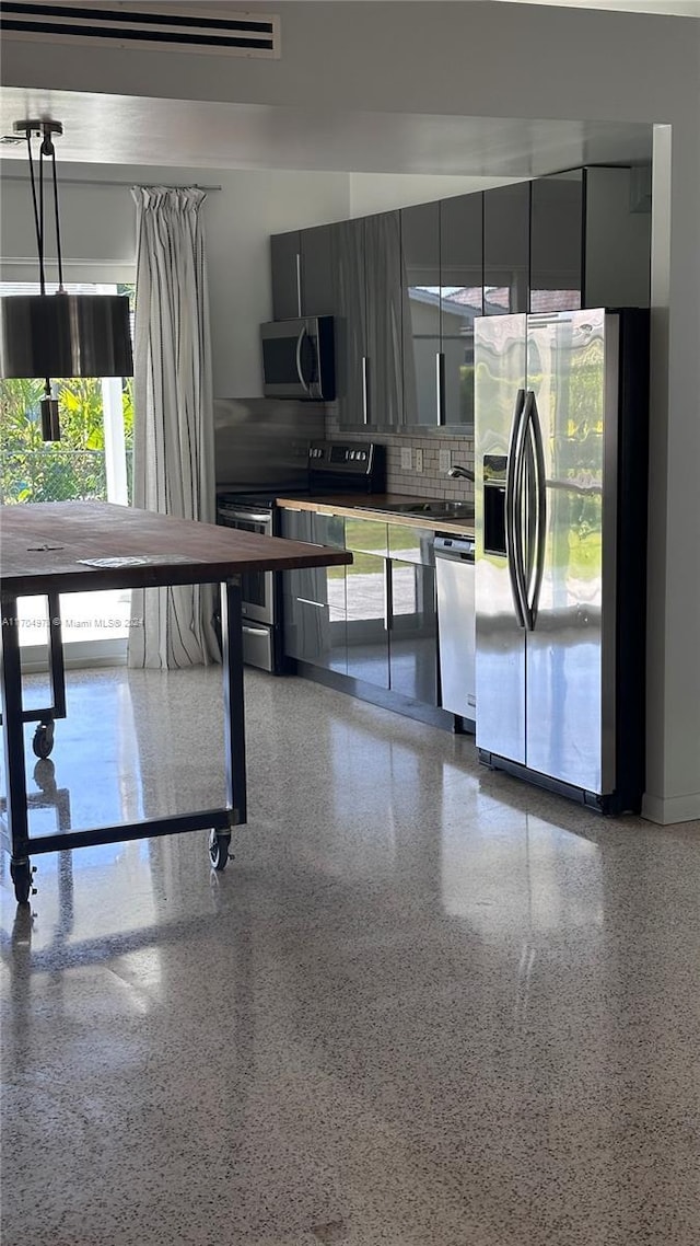 kitchen featuring decorative backsplash, sink, and appliances with stainless steel finishes