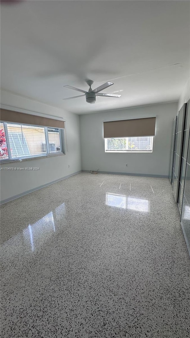 unfurnished room with ceiling fan