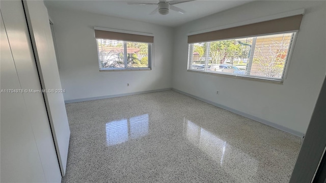 empty room featuring plenty of natural light and ceiling fan