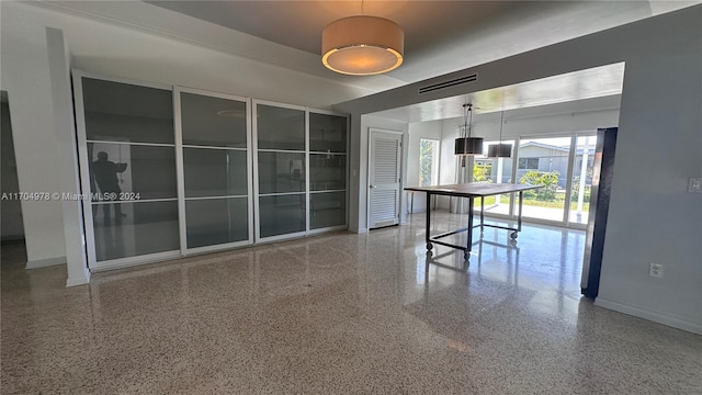 interior space with stainless steel fridge and hanging light fixtures