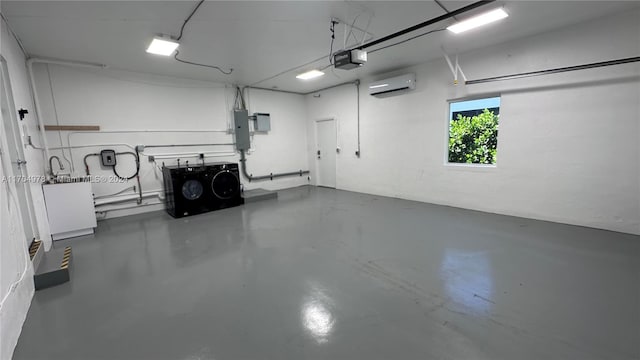 garage with a garage door opener, electric panel, and a wall mounted AC