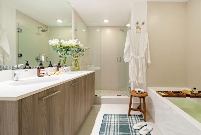 bathroom featuring tile patterned flooring, vanity, and a shower with shower door