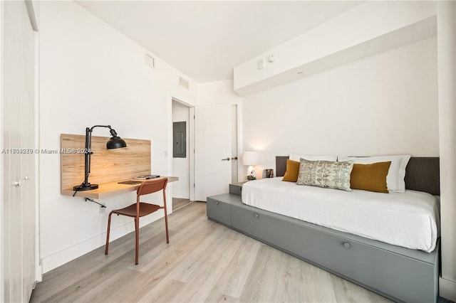 bedroom with hardwood / wood-style flooring and electric panel