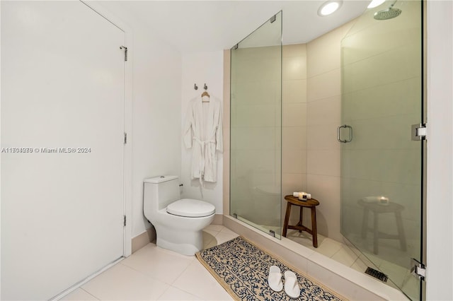 bathroom with tile patterned flooring, toilet, and walk in shower