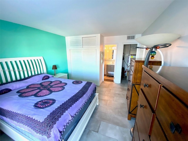 tiled bedroom featuring ensuite bathroom