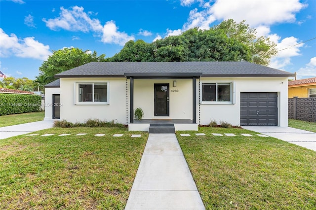 single story home with a garage and a front yard