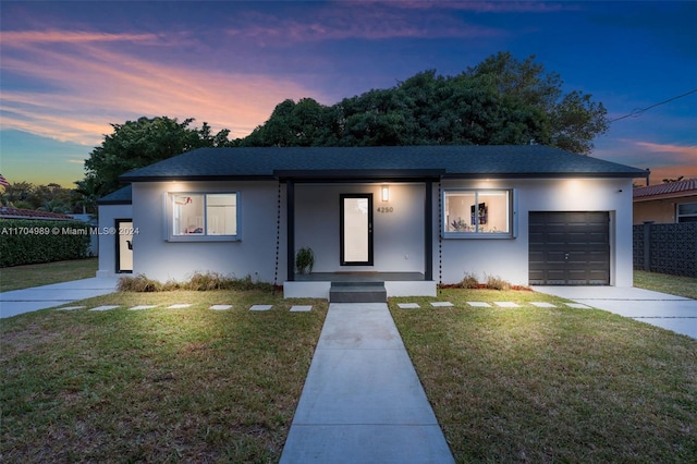 view of front of house with a lawn and a garage