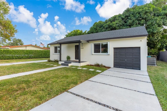 single story home featuring a garage and a front lawn