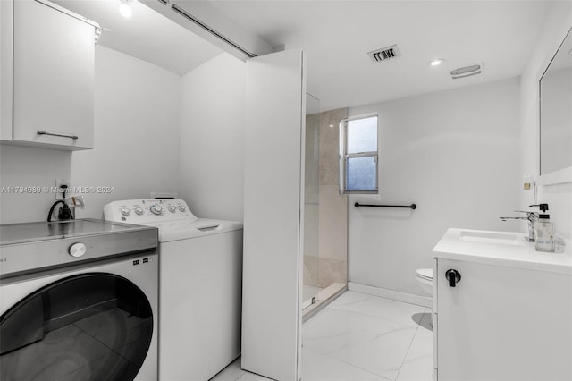 laundry area featuring washing machine and dryer and sink