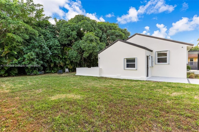 back of house with a yard and a patio area