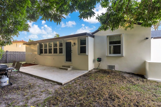 rear view of house featuring a patio