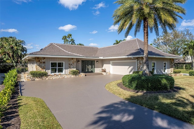 single story home with a front lawn and a garage