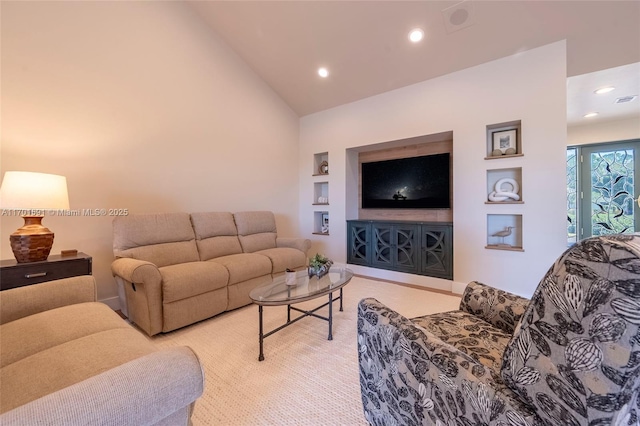 living room with light carpet, built in features, and high vaulted ceiling