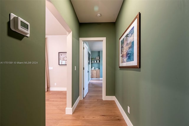 hallway with light hardwood / wood-style flooring