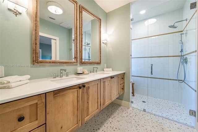 bathroom with vanity and a shower with shower door