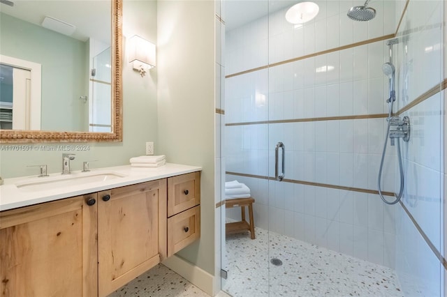 bathroom featuring vanity and a shower with shower door