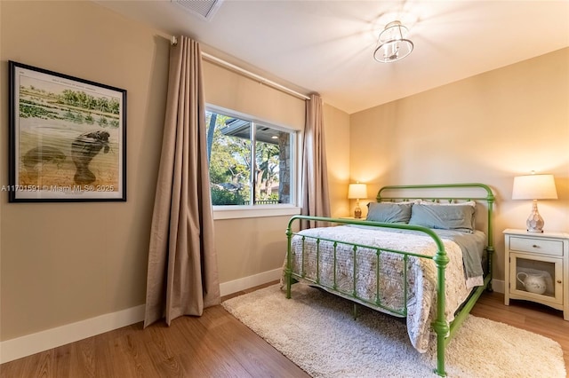 bedroom with hardwood / wood-style flooring