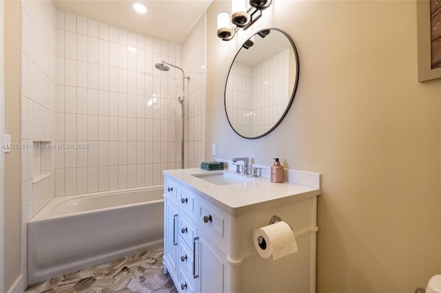 bathroom with tiled shower / bath and vanity