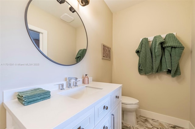 bathroom featuring vanity and toilet