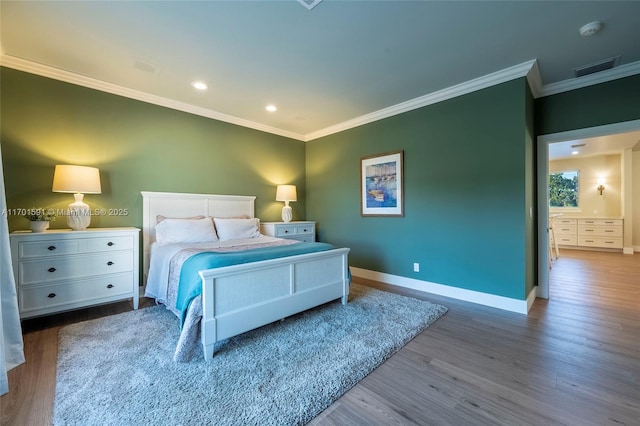 bedroom with ornamental molding and wood-type flooring