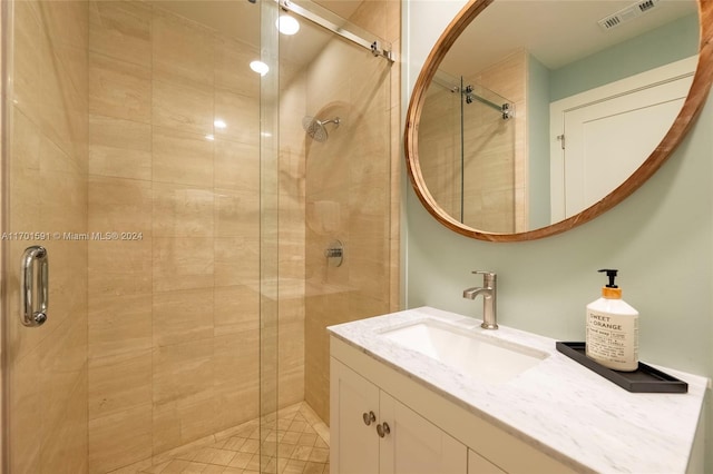 bathroom with vanity and a shower with door