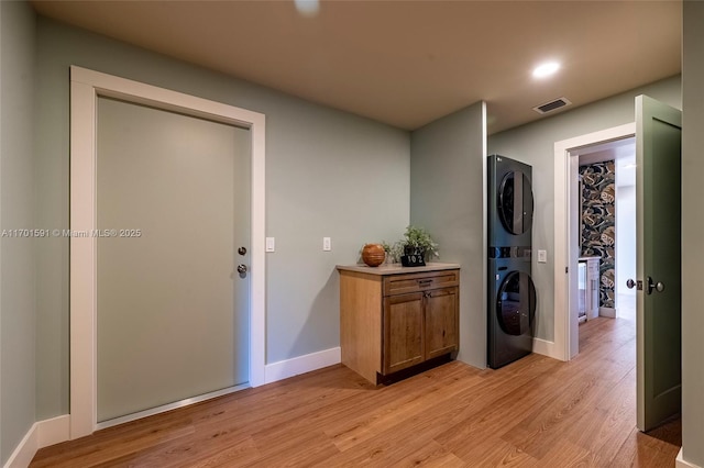 interior space with stacked washer / dryer and light wood-type flooring