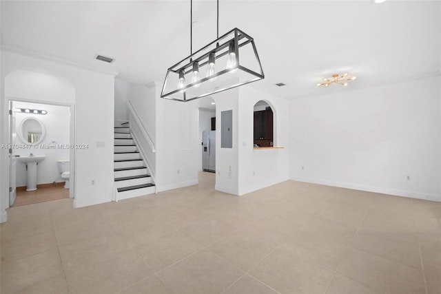 unfurnished living room with light tile patterned flooring and sink