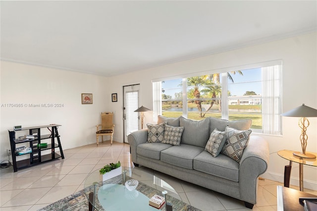 living room featuring a wealth of natural light, light tile patterned flooring, and ornamental molding