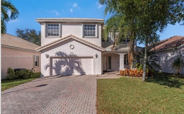 view of front facade with a garage and a front lawn