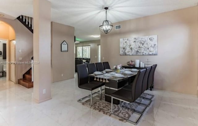 dining space with a notable chandelier