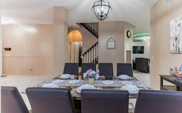 carpeted dining space with a chandelier