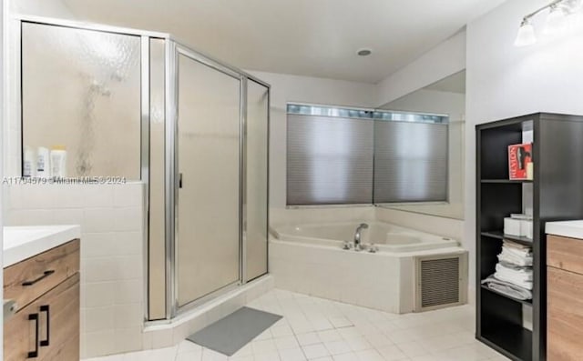 bathroom featuring vanity, tile patterned floors, and independent shower and bath