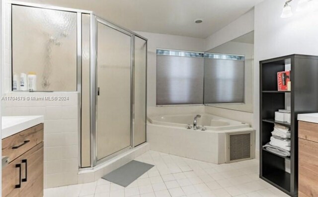 bathroom with tile patterned floors, plus walk in shower, and vanity