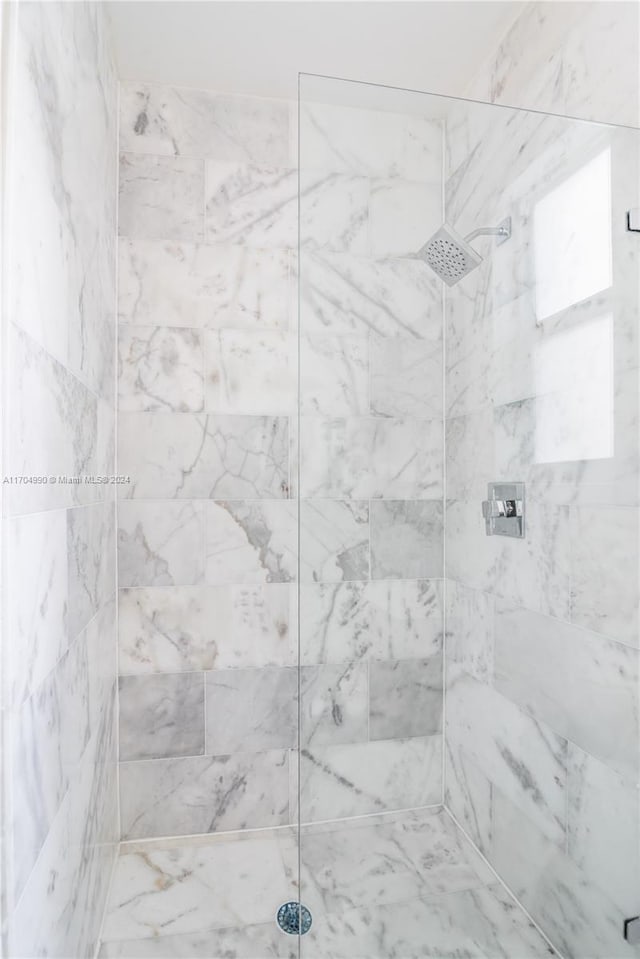 bathroom with tiled shower