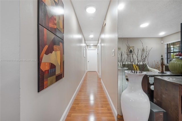 hall with light hardwood / wood-style floors