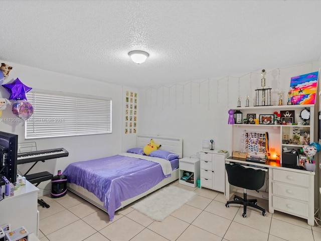 bedroom with light tile patterned flooring and a textured ceiling